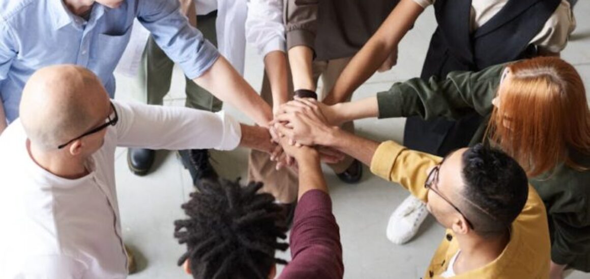 photo of people holding each other s hands