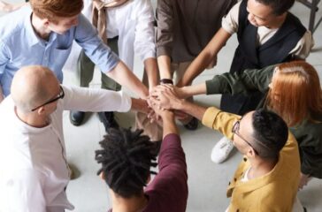 photo of people holding each other s hands