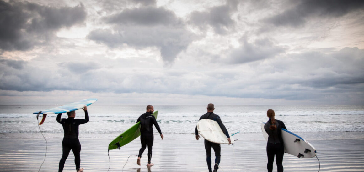 Surfers_at_La_Jolla_Shores_beach_-_courtesy_Visit_California