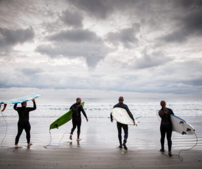 Surfers_at_La_Jolla_Shores_beach_-_courtesy_Visit_California