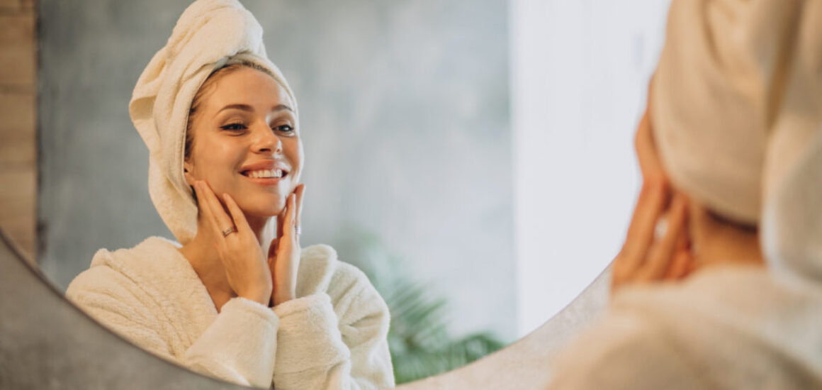 Woman at home applying cream mask