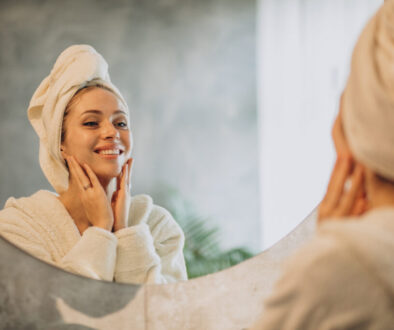 Woman at home applying cream mask